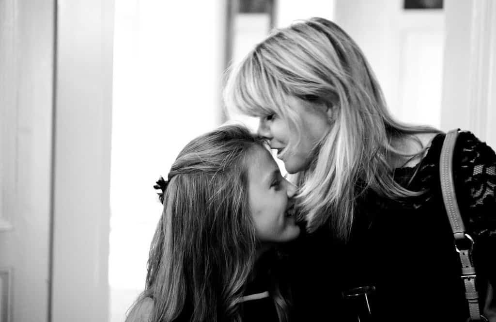Danish mother kissing daughter b&w
