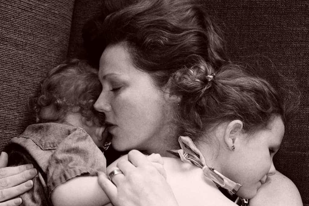 Italian mother hugging two children closeup b&w