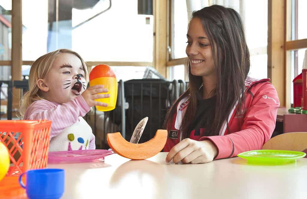 Toddler having snack at day care center in Norway