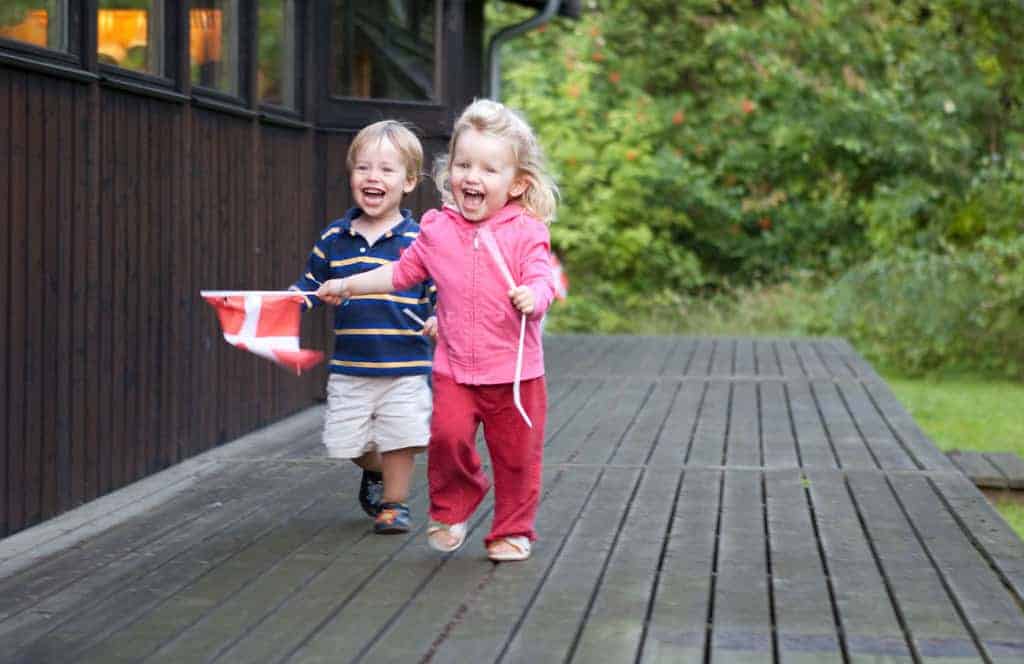 Toddlers running with the Danish Flag