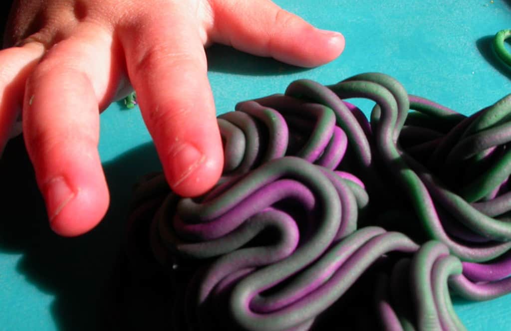 Toddler fingers touch homemade playdough