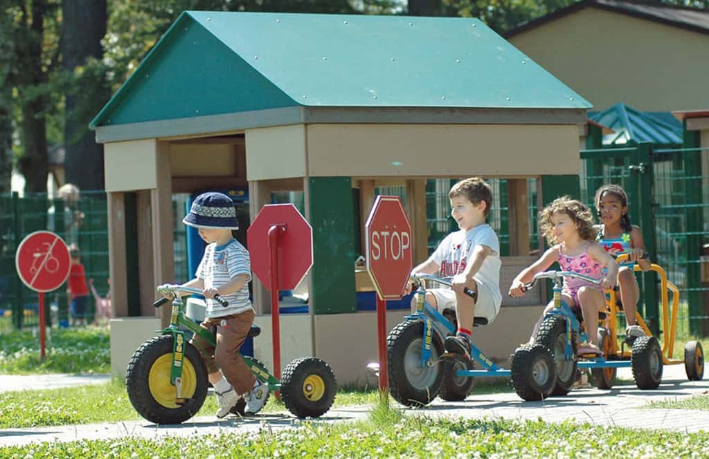 Preschoolers riding toy vehicles at a Child Development Center Supported by Army Family Covenant initiatives