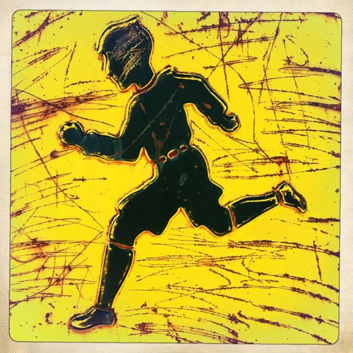 Boy running on yellow background