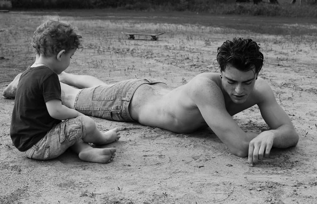 Dad and son talking on beach