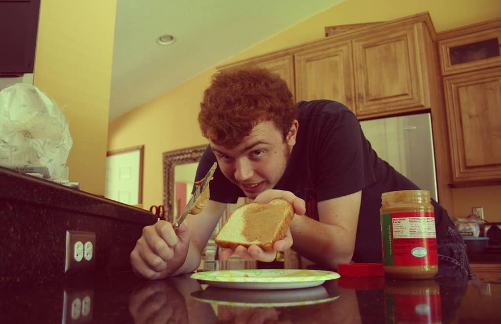 Dad making PBJ with son