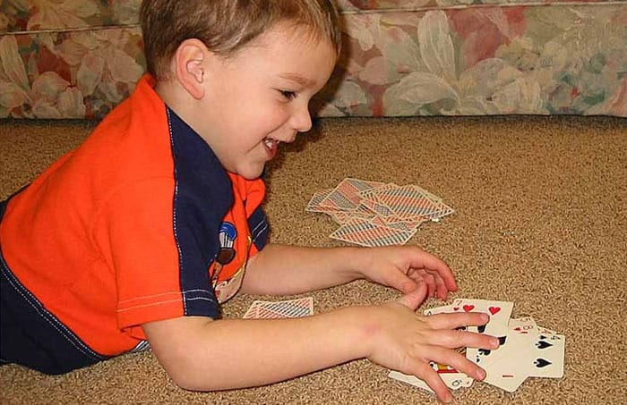 Kid playing slapjack cards